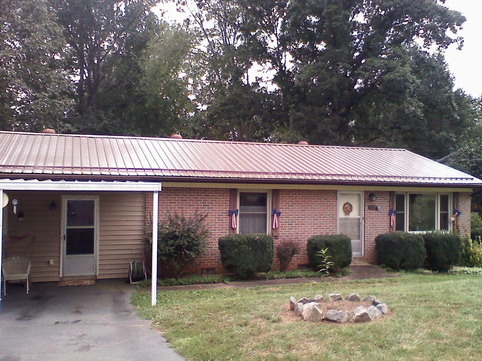 Bronze metal roof and carport on a brick ranch home — Roof Repair work by our crew in Belmar